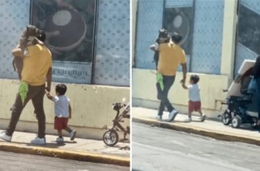 Homem carrega cachorro da família no colo para que ele não ande no chão quente